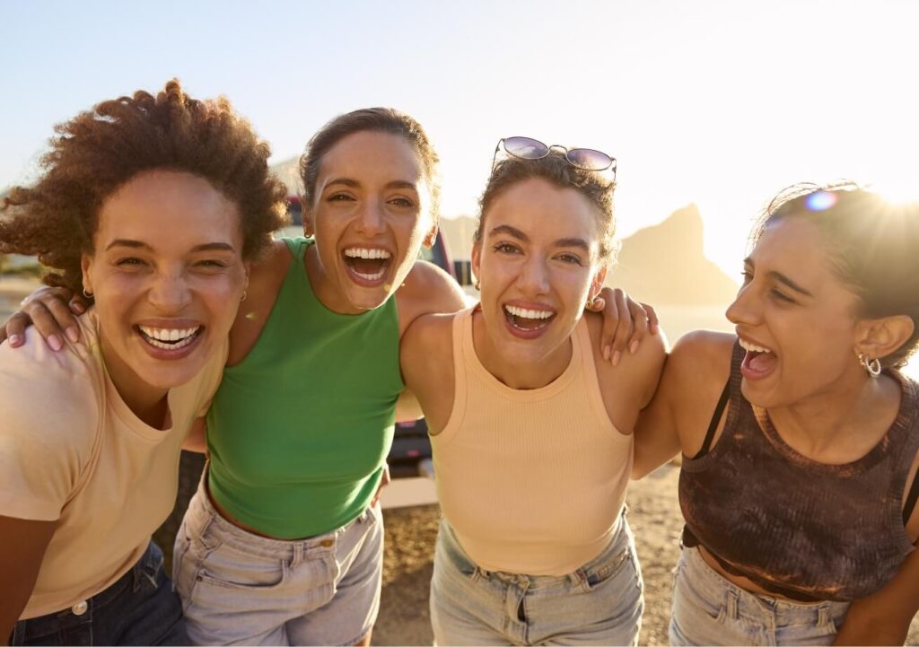 portrait-of-smiling-female-friends-standing-by-car-2023-11-27-04-55-39-utc (1)