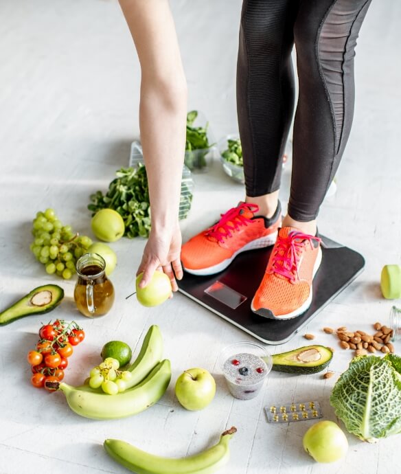 sports-woman-weighing-with-healthy-food-around-2023-11-27-05-15-41-utc (1)