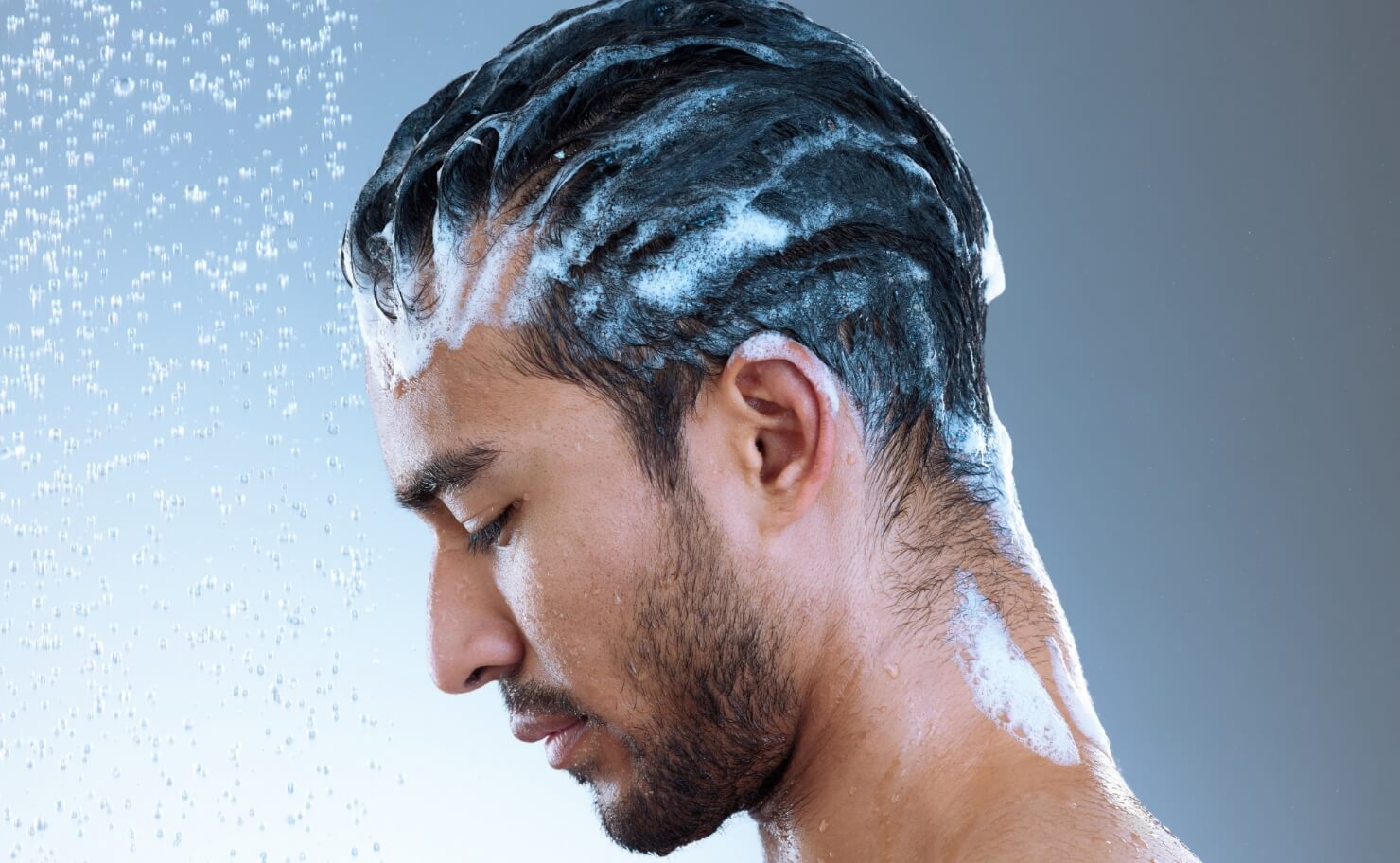 studio-shot-of-a-handsome-young-man-washing-his-ha-2023-11-27-05-21-59-utc (1) (1)